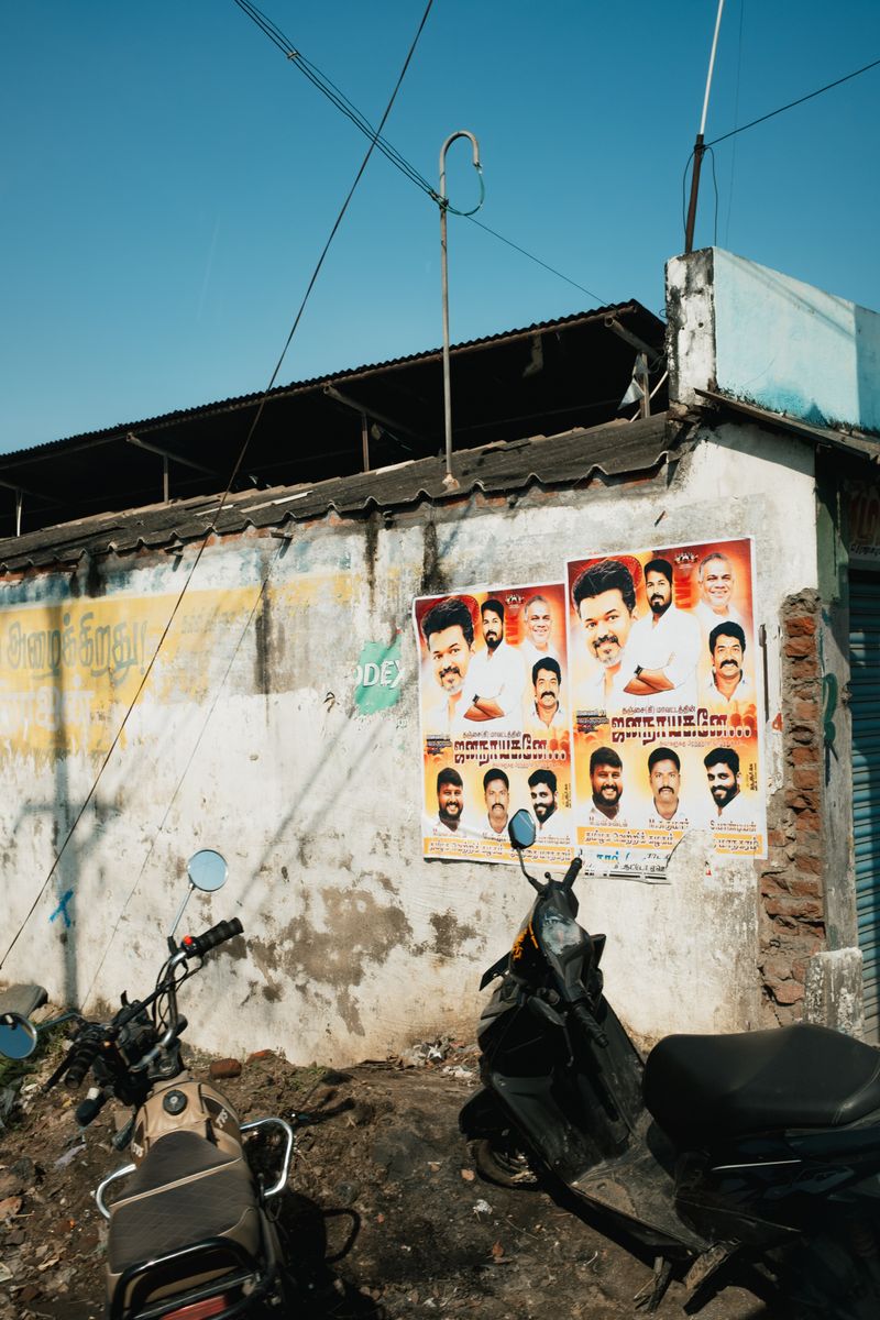 © Yvonne Chu - Posters on a wall-threshold; public images hover behind private errands and faces.