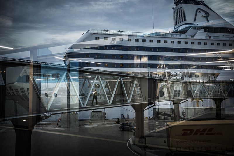 © Nina Varumo - Headwaiter and bar chef Anne-Sophie on her way back to the cruise ship after sorting some errand on land.