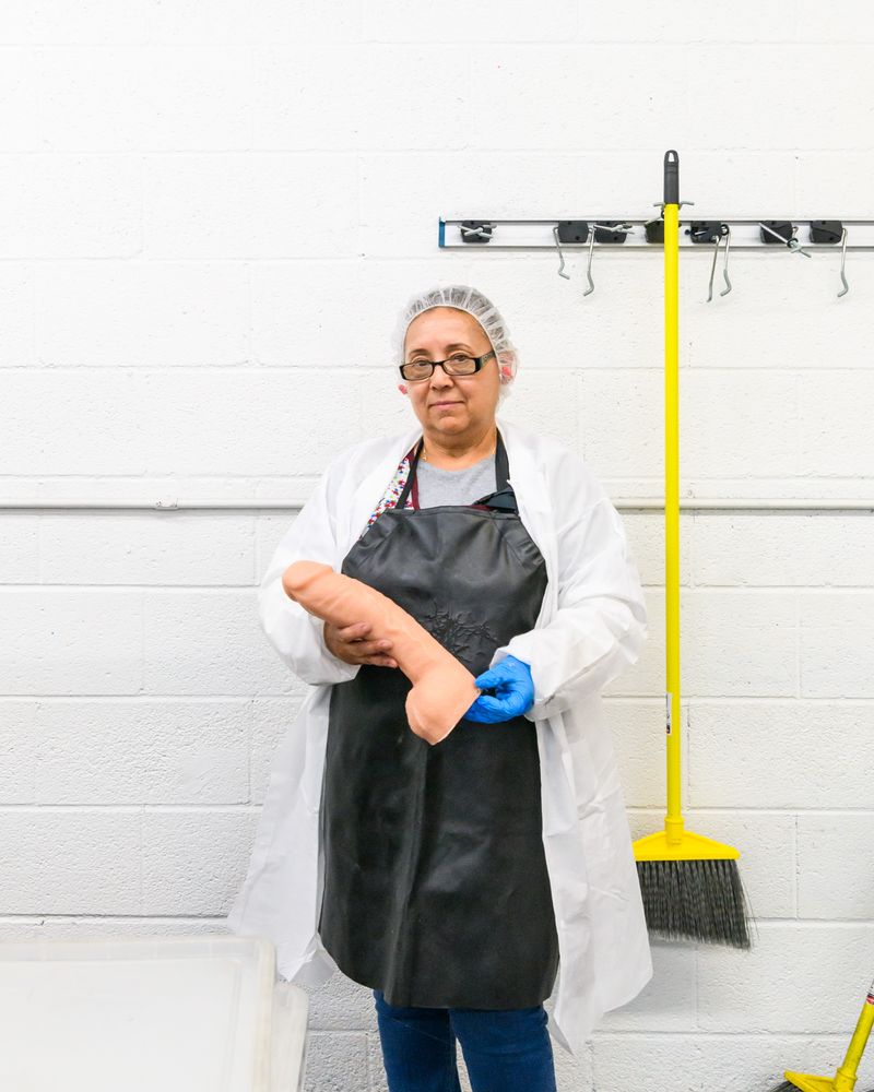© Alastair Philip Wiper - An employee with a freshly moulded Doc Johnson dildo, at the factory in Los Angeles.