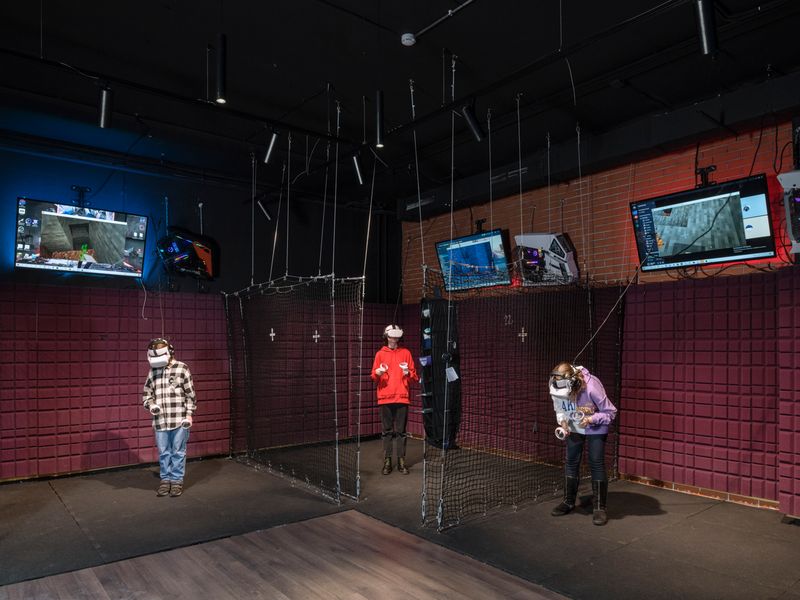 © Lorenzo Maccotta - Russian Federation, Moscow, December 2021: teen-agers playing in a virtual reality game room.