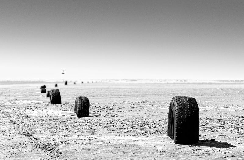 © Sergio Fadul - 8.	Improvised Boundary — Ceará, 2026(Tires marking the road, sign in background — Tatajuba)