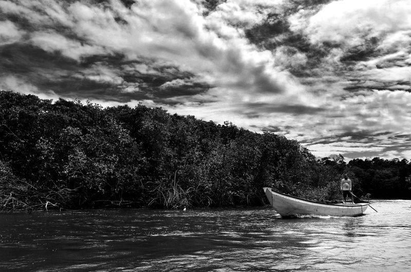 © Sergio Fadul - 3.	Tidal Presence — Maranhão, 2022(Fisherman in boat, mangrove background — Delta do Parnaíba)