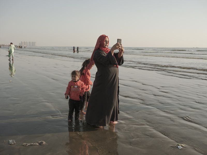 © Jo Ann Walters - mother w children making selfie, untitled from series The Arabian Sea:Until Their Bodies Glowed, 2023