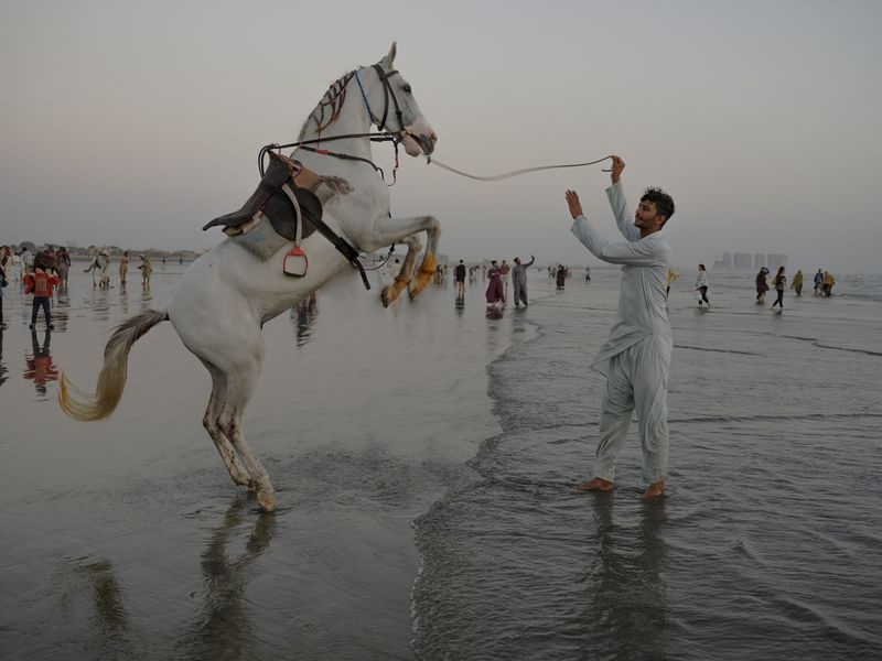 © Jo Ann Walters - vendor + bucking horse, untitled from series The Arabian Sea:Until Their Bodies Glowed, 2023