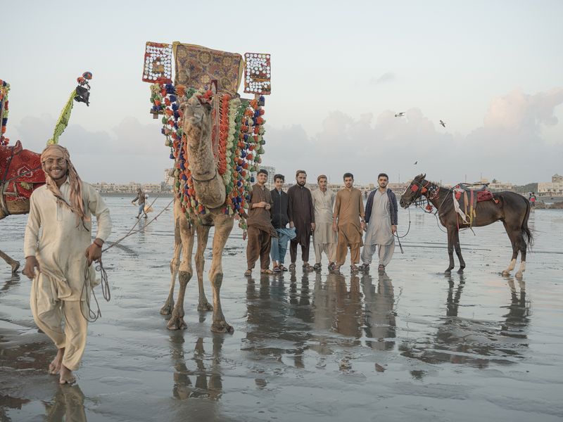 © Jo Ann Walters - vendors w camel + horse + crowd, untitled from series The Arabian Sea:Until Their Bodies Glowed, 2023