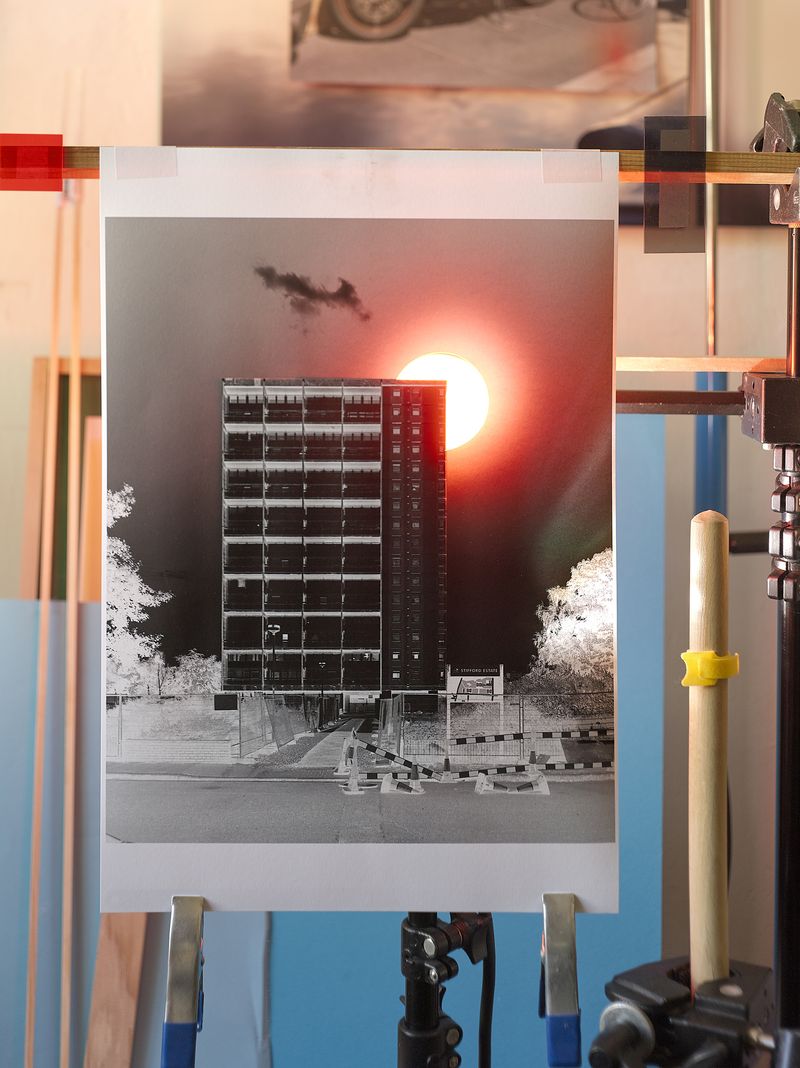 The building stands tall against the sky, with a bright sun shining in the background