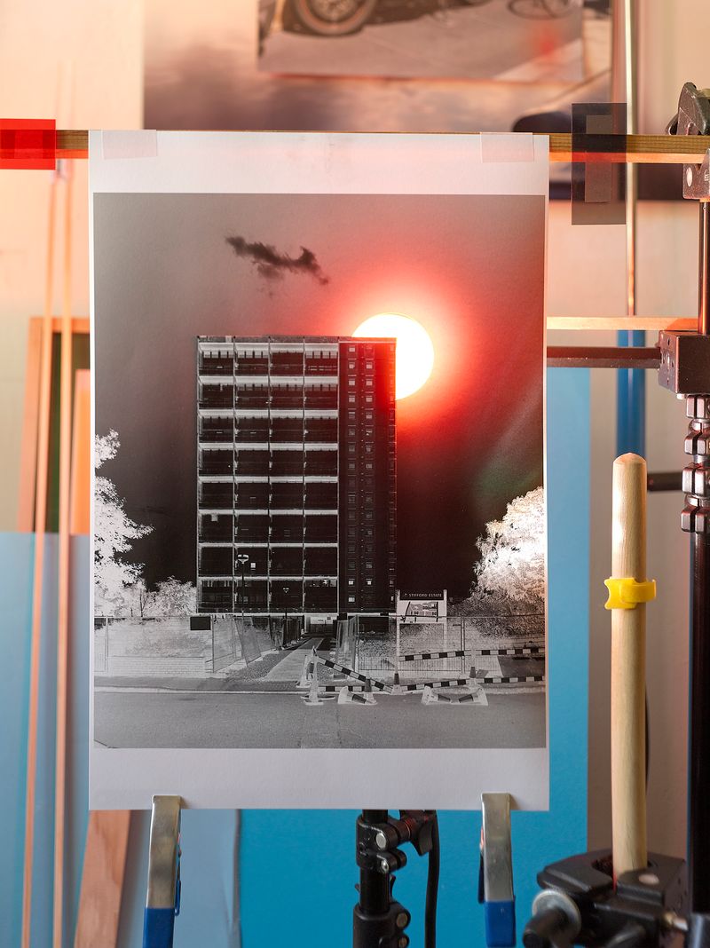 The building stands tall against the sky, with a bright sun shining in the background