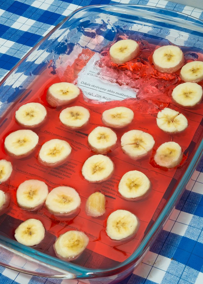 © Dominik Wojciechowski - marriage certficate frozen in a strawberry jelly with a cut banana.