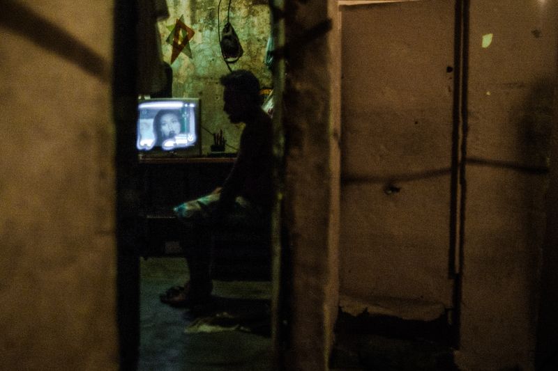 © Celine Croze - Jose sitting in his room after losing all three of his roosters in battle. Caracas, Venezuela, 2015