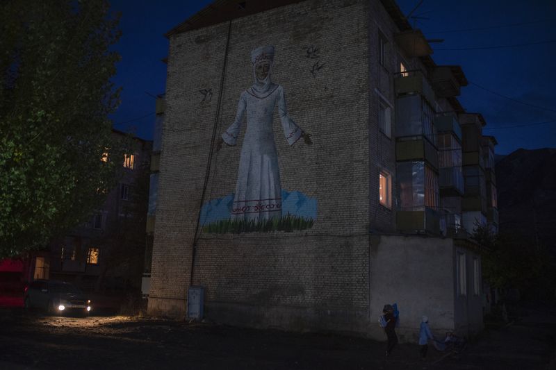 © Irina Unruh - A building with a mural of a woman in national clothes is a few meters from the family home.