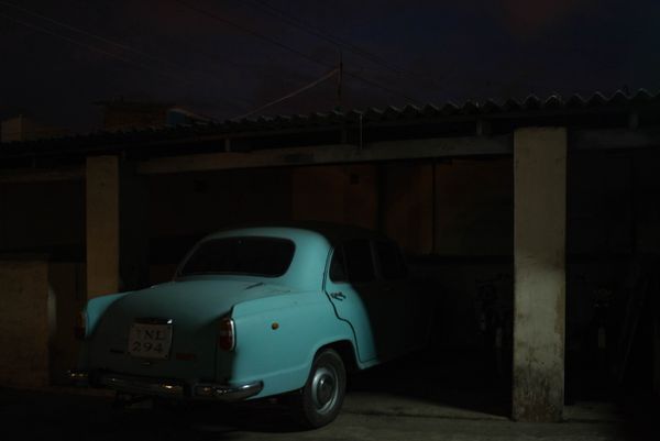 © Balaji Maheshwar - A car parked inside a cinema hall that was shut down