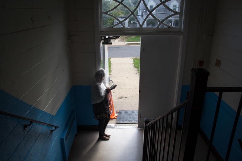 © Hilina Abebe - A woman stands by the entrance of the Holy Trinity Ethiopian Orthodox Church in Falls Church, VA after Sunday service.
