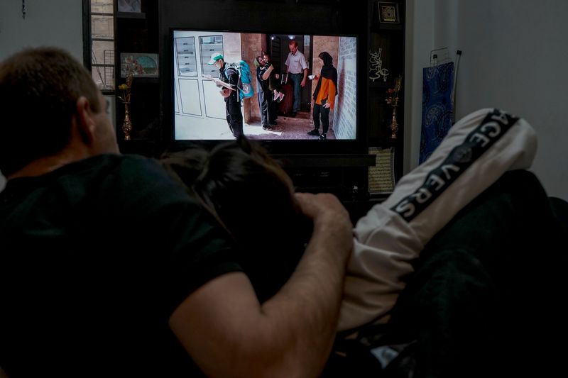 © Ali Rad - Her family watches the photos and videos of the day she left Iran with sorrow.
