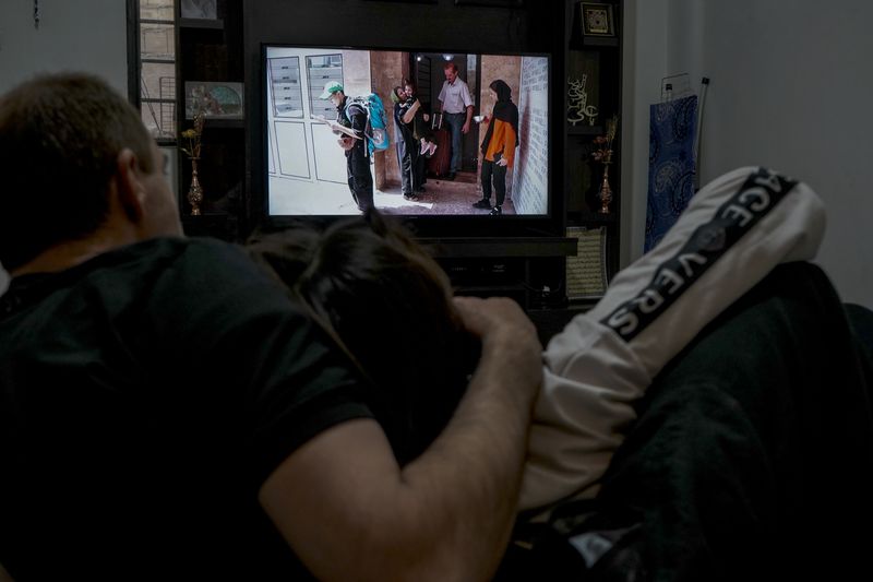 © Ali Rad - Her family watches the photos and videos of the day she left Iran with sorrow.