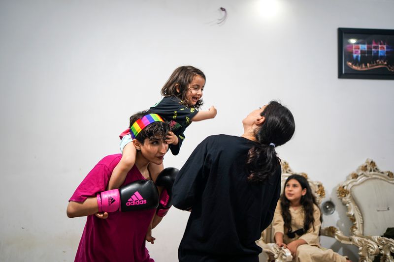 © Ali Rad - Hanieh is playing with her daughter and sister at home.