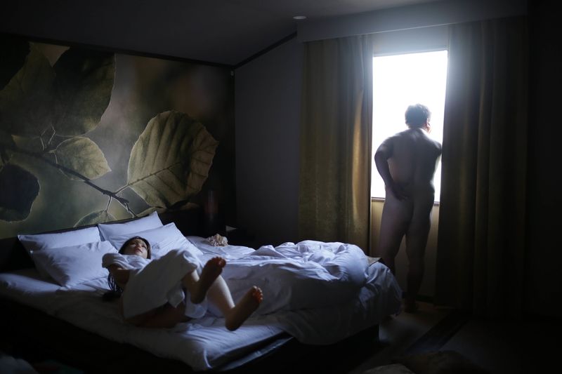 © Taro Karibe - Senji Nakajima watches outside of a Love Hotel room on September 27, 2016 in Kanagawa, Japan.