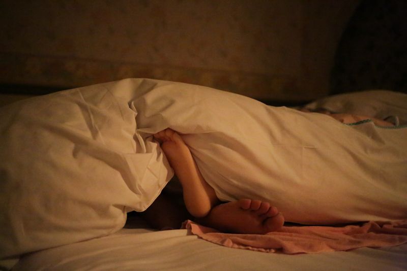 © Taro Karibe - Feet of Senji Nakajima and his Love Doll 'Saori' at Love Hotel room on June 5, 2016 in Nagano, Japan.