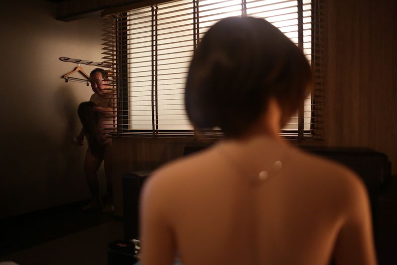 © Taro Karibe - Senji Nakajima carries the spare wig for his Love Doll 'Saori' at a Love Hotel room on September 27, 2016 in Tokyo, Japan.