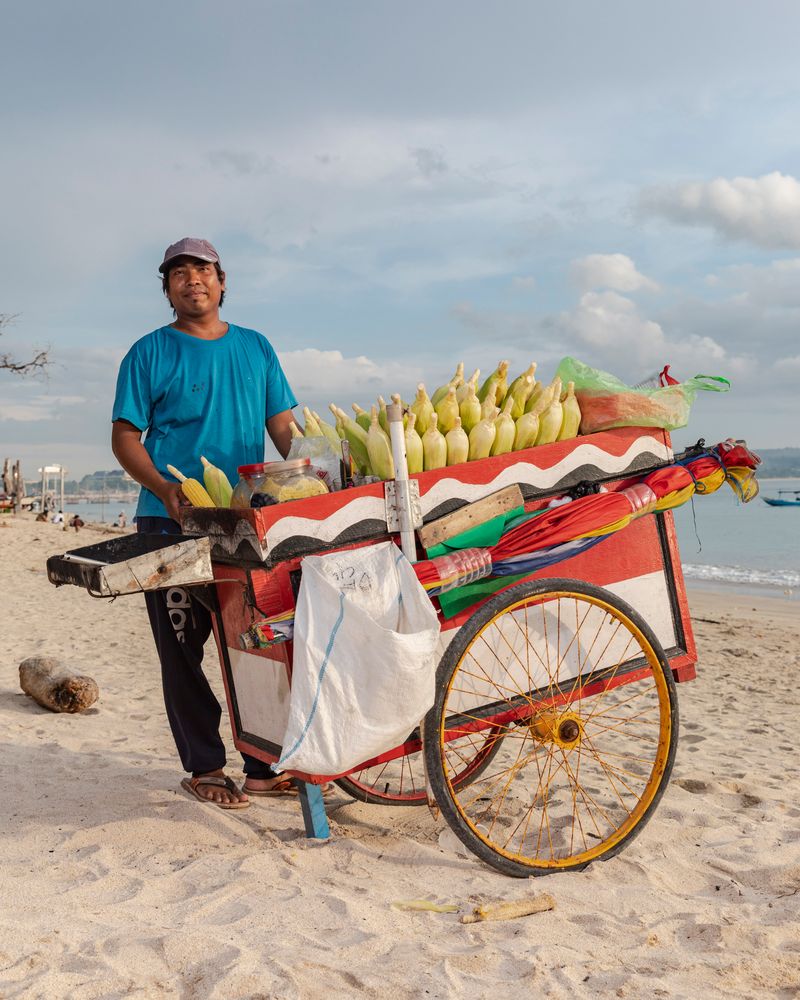 © Nyimas Laula - Lalu, 30, sells roasted corn and steamed peanuts at Kelan Beach in South Kuta, Bali.