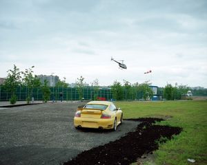 Trees, cars, figures of people, assorted barriers