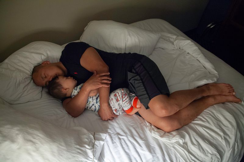 © Arin Yoon - John holds Teo, the night before leaving for his first combat deployment as a father in 2015, Fort Stewart, Georgia.