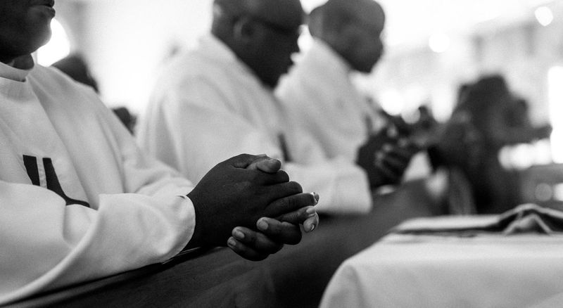 © Cole Ndelu - Close up of priest in prayer