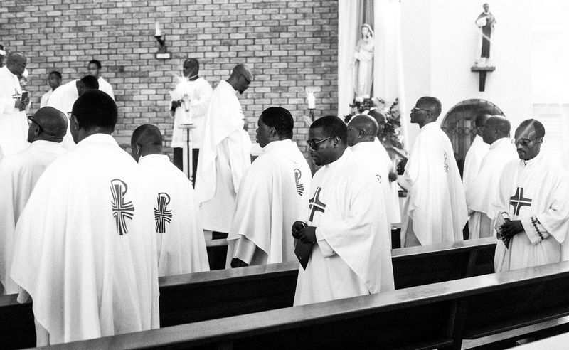 © Cole Ndelu - Priests taking their places in the church.