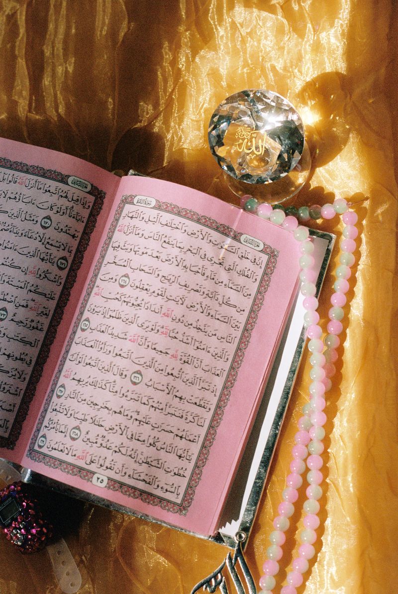 © Najla Said - A crystal with the name of God, Allah, used for home decor; as well as a rainbow Quran, and rosary beads.