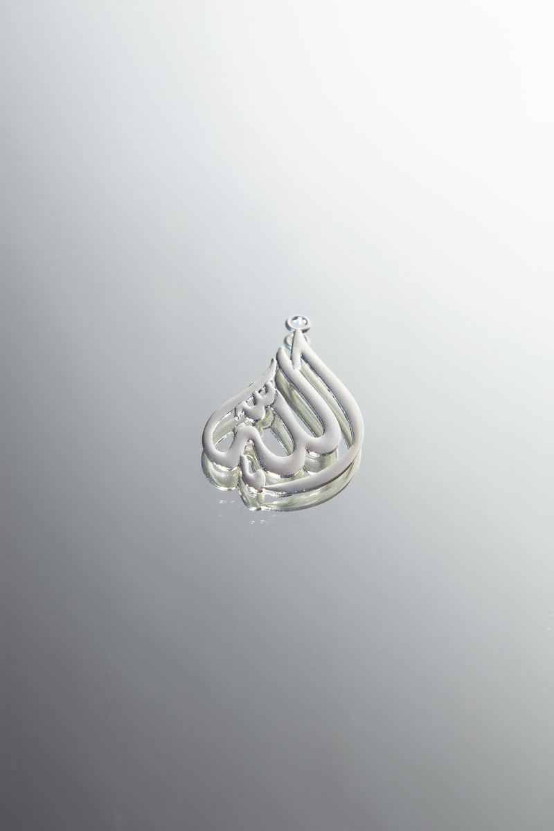 © Najla Said - A pendant of the name of God, Allah, commonly worn as a necklace.
