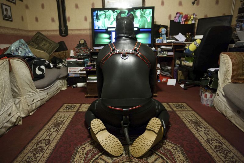 © Erik Messori - Chip, a 48-year-old father of two, relaxes at home in the family living room.