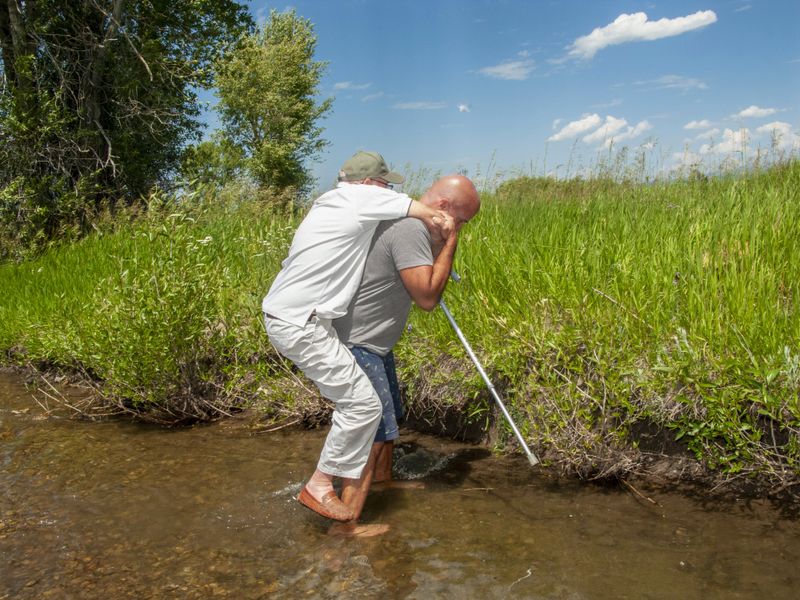 © Natalie Behring - My brother carrying my 93 year old father over a small creek on our family farm in Driggs, Idaho.