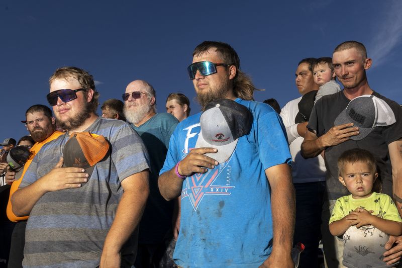 © Natalie Behring - Patriots during the national anthem at Figure 8 racing at the Teton County Fair in Driggs Idaho August 12, 2023.