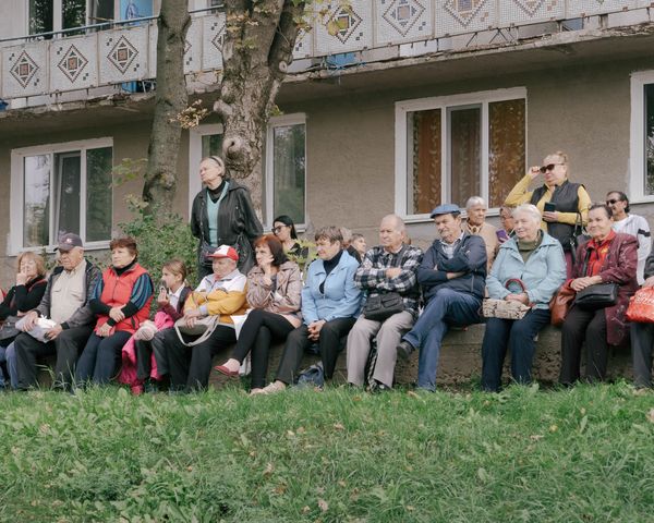 © Julius Nieweler - Retirees watch Victoria Fortuna's campaign event in their neighborhood of Rîșcani, in the Moldovan capital of Chișinău.