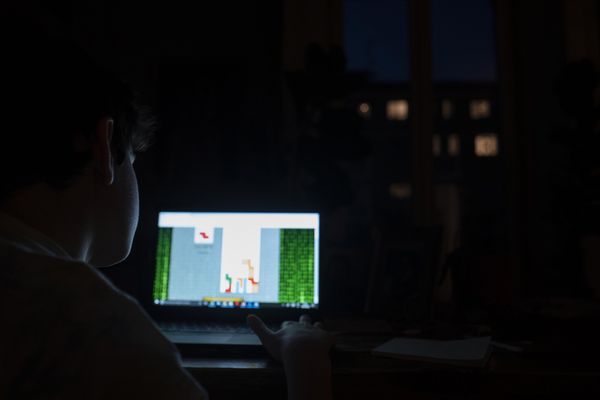 © Paolo Bona - Milan, Italy April 18, 2020My son Mario, 10 years old, plays Tetris on laptop late at night.