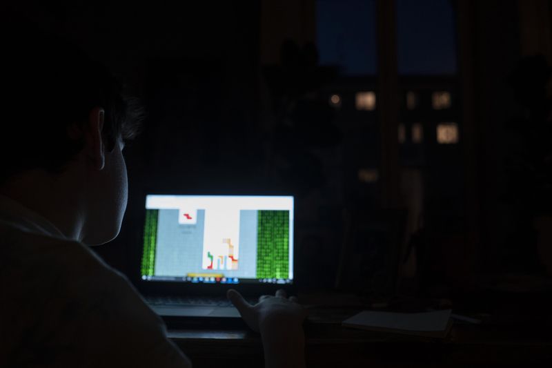 © Paolo Bona - Milan, Italy April 18, 2020My son Mario, 10 years old, plays Tetris on laptop late at night.