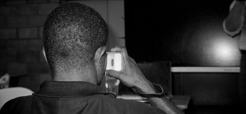 © Sean Davey - Young boy on phone. (2025)