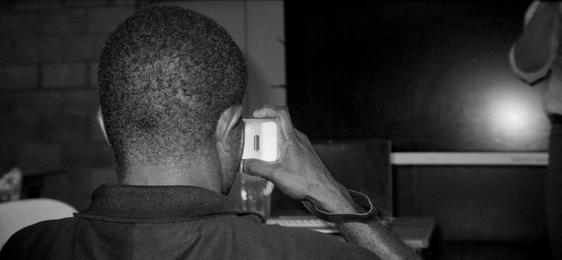 © Sean Davey - Young boy on phone. (2025)