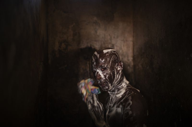 © Diego Ibarra Sánchez - Mile 2, Banjul: Remand prisoner takes shower inside the dilapidated shared bathroom at the remand wing.