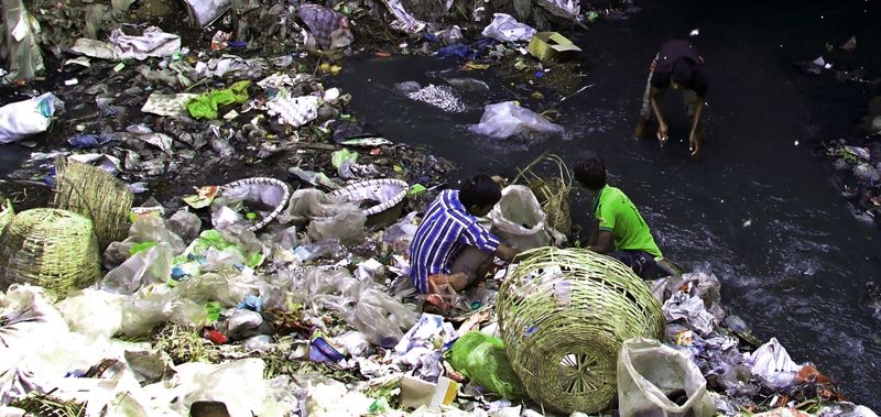 © Tahsin Ahmed - 3 street children, searching waste beside Zirani Canal at Nandipara area in Dhaka.