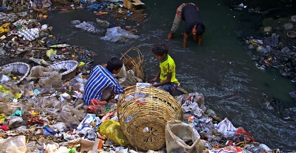 © Tahsin Ahmed - 3 street children, searching waste beside Zirani Canal at Nandipara area in Dhaka.