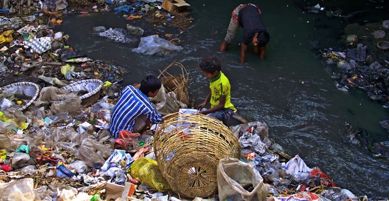 © Tahsin Ahmed - 3 street children, searching waste beside Zirani Canal at Nandipara area in Dhaka.