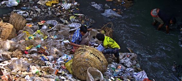 © Tahsin Ahmed - 3 street children, searching waste beside Zirani Canal at Nandipara area in Dhaka.