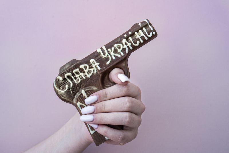 © Marylise Vigneau - Chocolate guns ornate with the ubiquitous "Slava Ukraïni" (Glory to Ukraine) in a confectionery shop in Odesa.