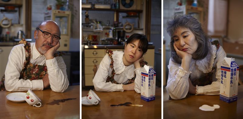 © Yuki Furusawa - Family, looking depressed, with spilled coffee and milk.