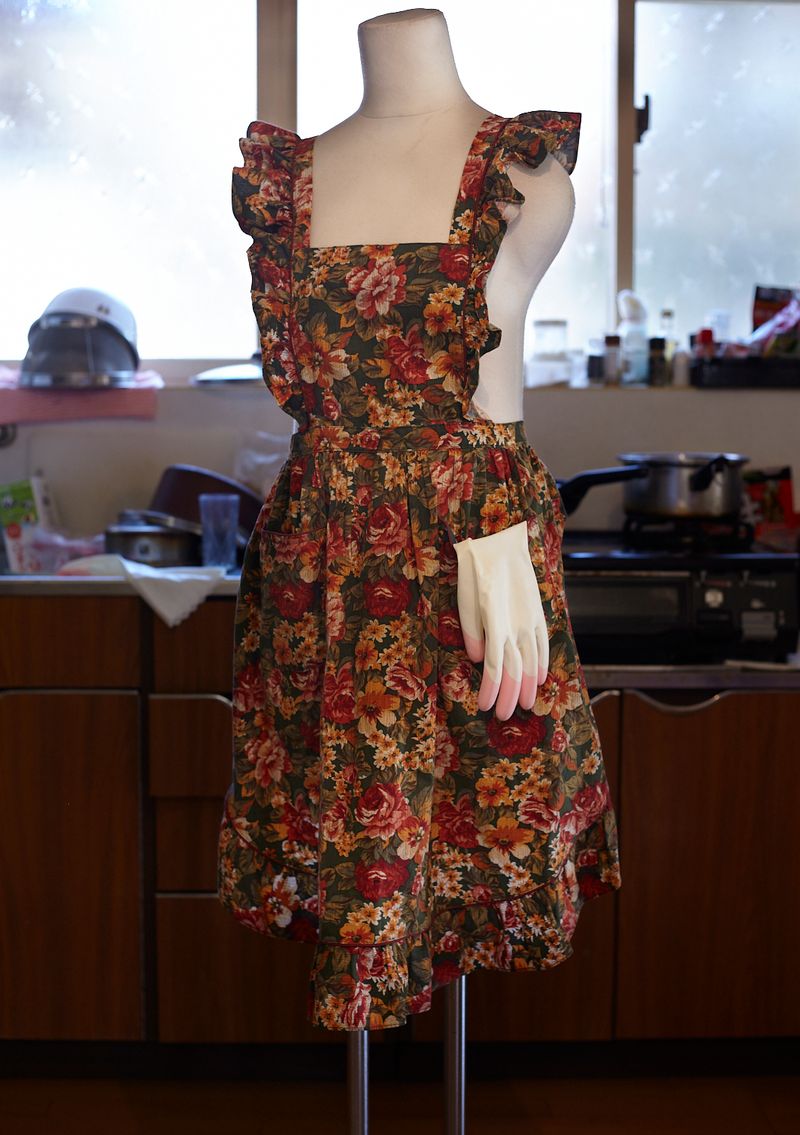 © Yuki Furusawa - An apron and a glove in the kitchen.