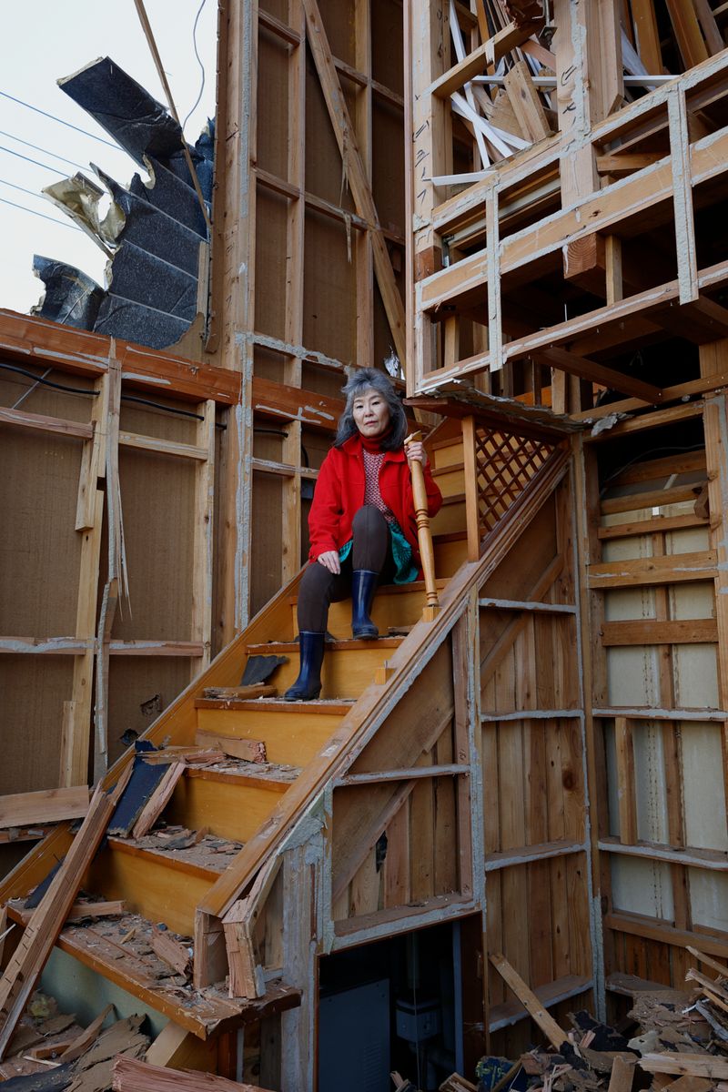 © Yuki Furusawa - My mother sitting on the exposed staircase during the demolition.