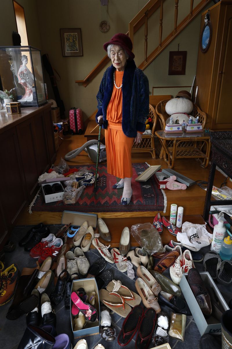 © Yuki Furusawa - My grandmother wearing her favorite outfit from her youth, surrounded by shoes that would soon be thrown away.