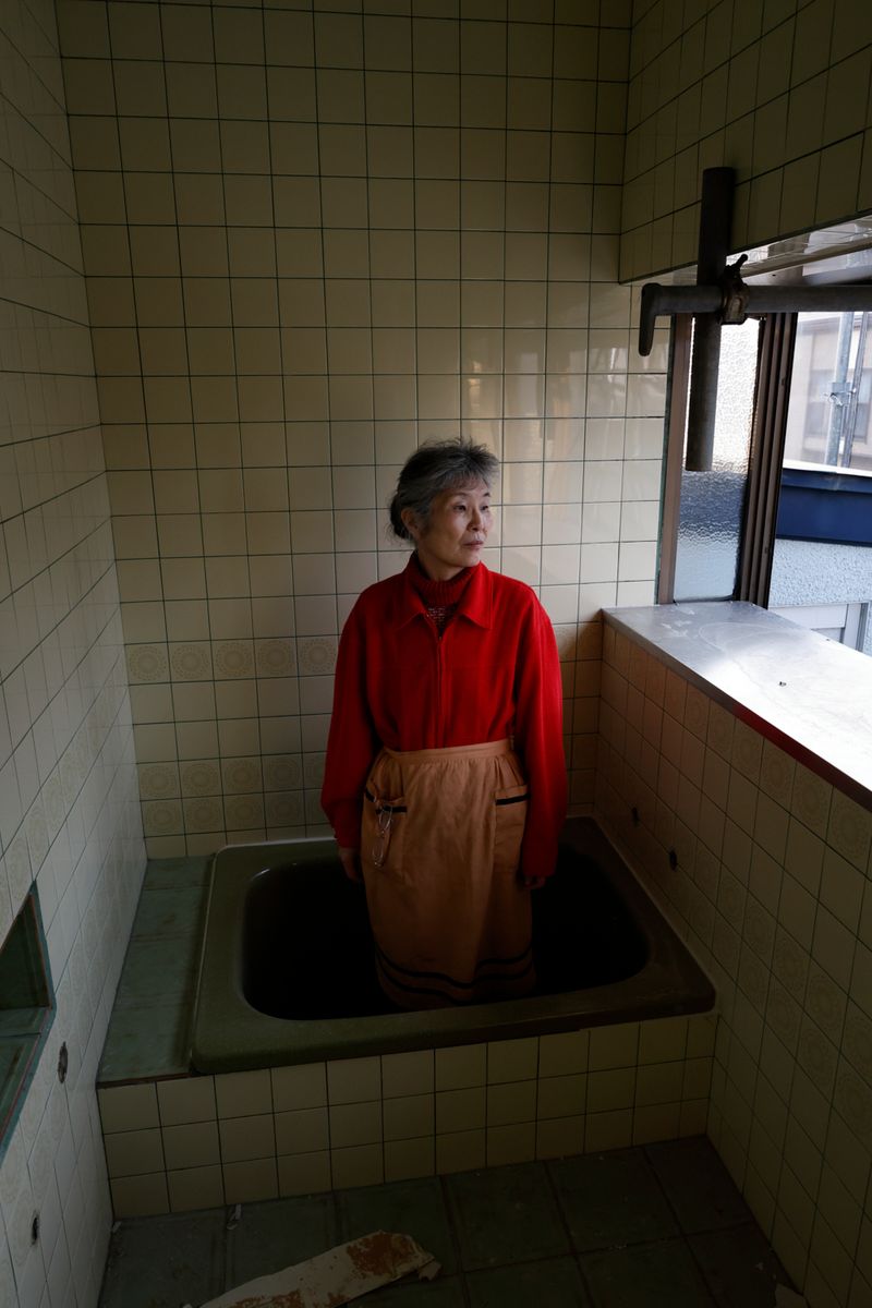 © Yuki Furusawa - My mother standing in the bathtub, reminiscing about her old memories there, which was about to be demolished.