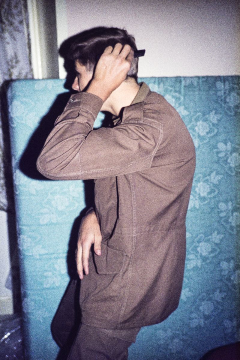 © Jansen van Staden - Pa, 17, in his browns, combing his hair before departing for service, White River, 1978
