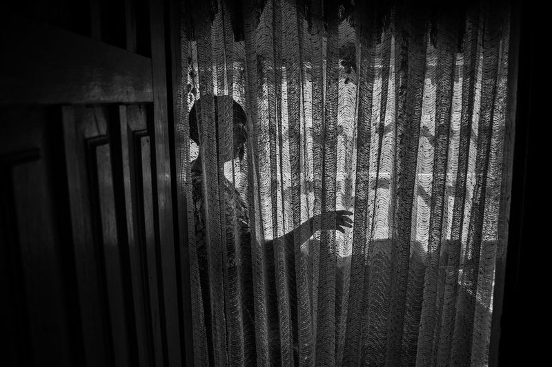 © Kuba Kaminski - A woman waiting for her turn in the Whisperers's Artemiuk house in Parcew village.